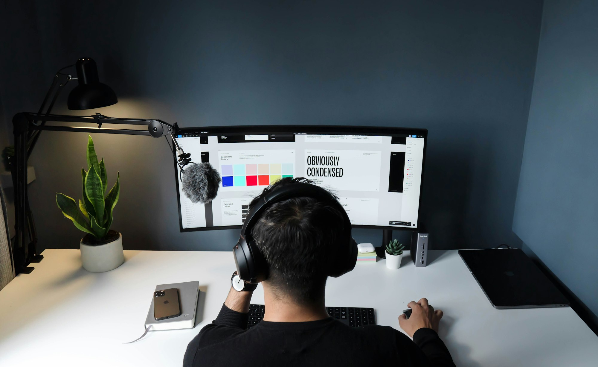 A designer working at a monitor in a dark studio